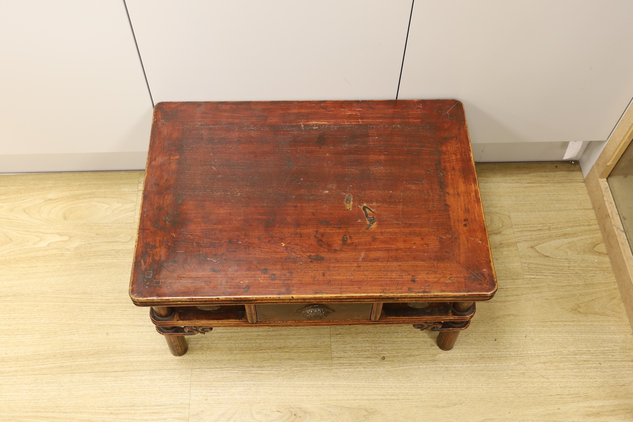 A Chinese elm and bamboo low table, fitted with three freezer drawers 63cms wide x 44cms deep x 32cms high